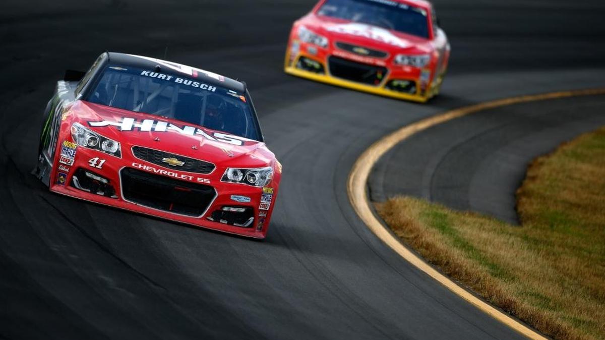 Kurt Busch, driver of the #41 Monster Energy/Haas Automation Chevrolet, races Dale Earnhardt Jr., driver of the #88 Axalta Chevrolet, during the NASCAR Sprint Cup Series Axalta "We Paint Winners" 400 at Pocono Raceway on June 6, 2016 in Long Pond, Pennsylvania.