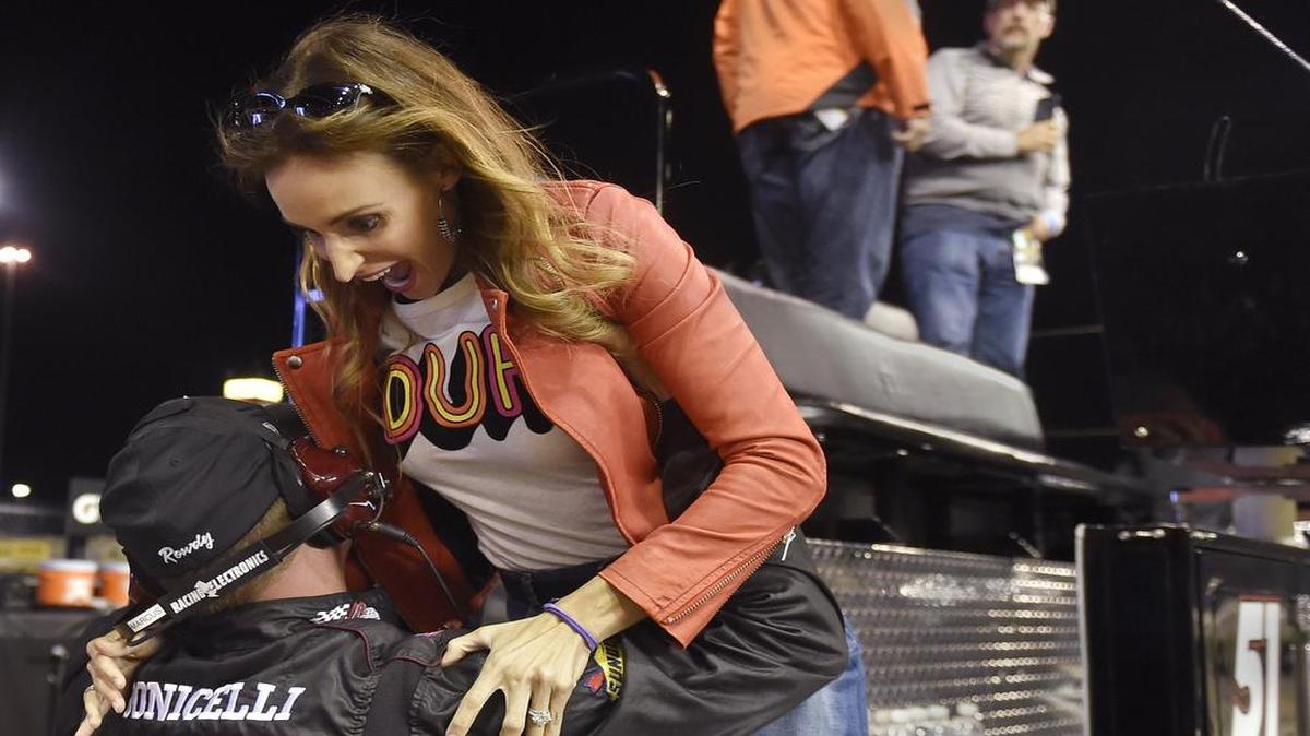 Just after her husband Kyle Busch won the NASCAR trucks race Friday night at Kansas Speedway, his wife Samantha jumped into the arms of a crew member and headed to victory lane.