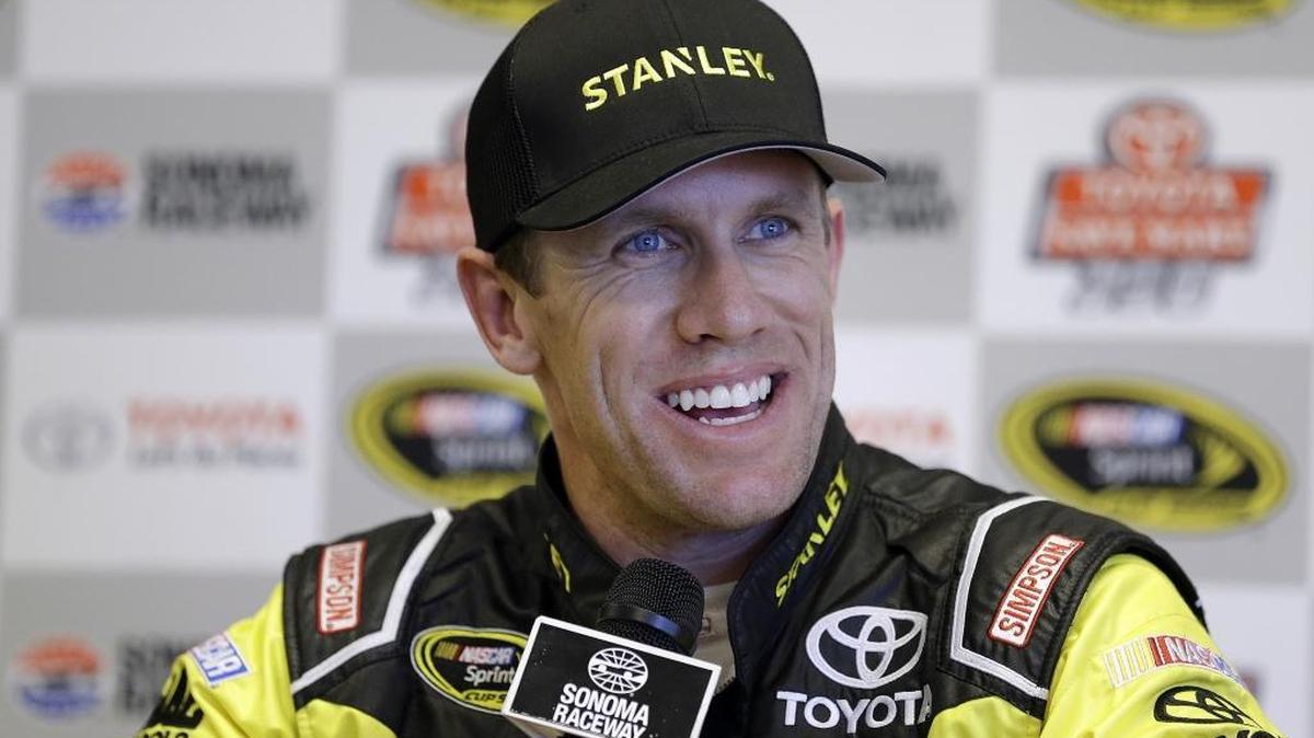 Carl Edwards smiles during a media conference after qualifying for the pole position for Sunday's NASCAR Sprint Cup Series auto race Saturday in Sonoma, Calif.