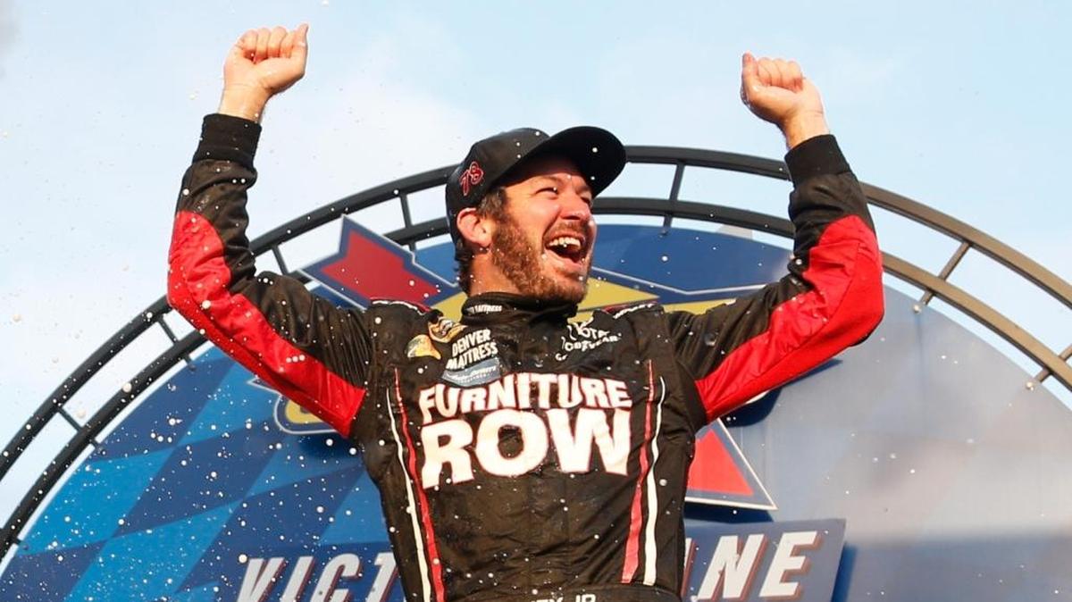 Martin Truex Jr. celebrates in Victory Lane after winning Sunday’s NASCAR Sprint Cup Series Citizen Soldier 400 at Dover International Speedway in Dover, Del.