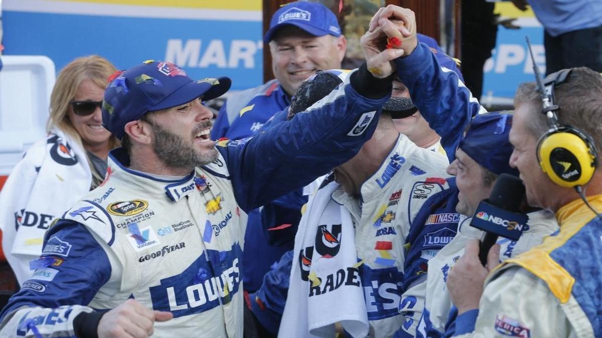 Jimmie Johnson, left, celebrates after winning Sunday’s NASCAR Sprint Cup Series race at Martinsville Speedway.