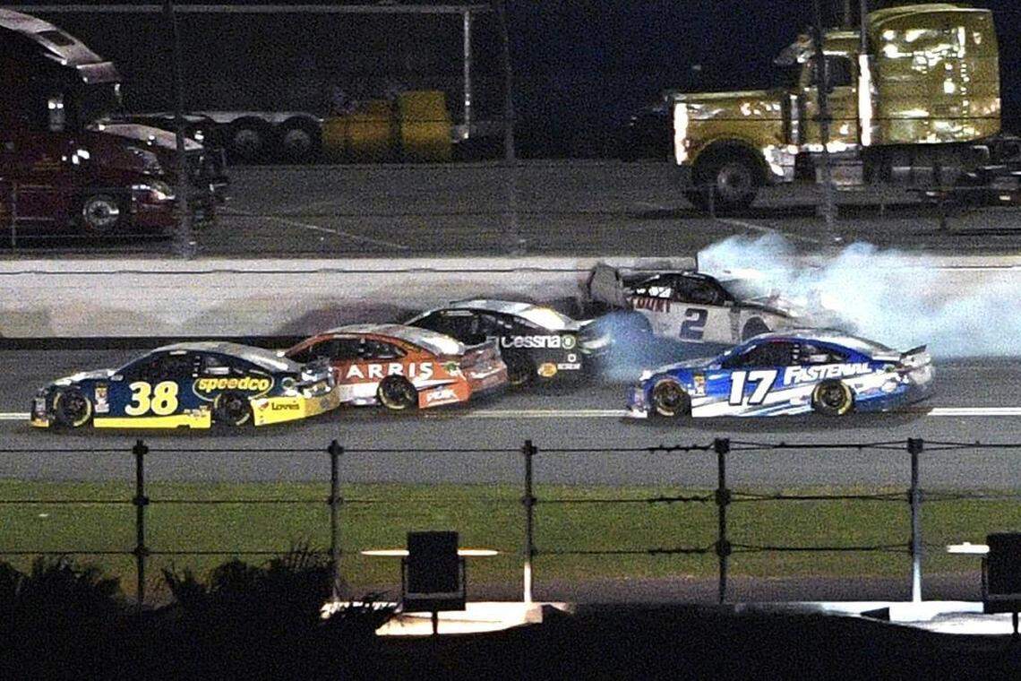 Brad Keselowski (2) scrapes the outside wall along the back stretch as David Ragan (38), Daniel Suarez, second from left, Jamie McMurray and Ricky Stenhouse Jr. (17) pass him during the first of Thursday’s qualifying races for the NASCAR Daytona 500 at Daytona International Speedway.