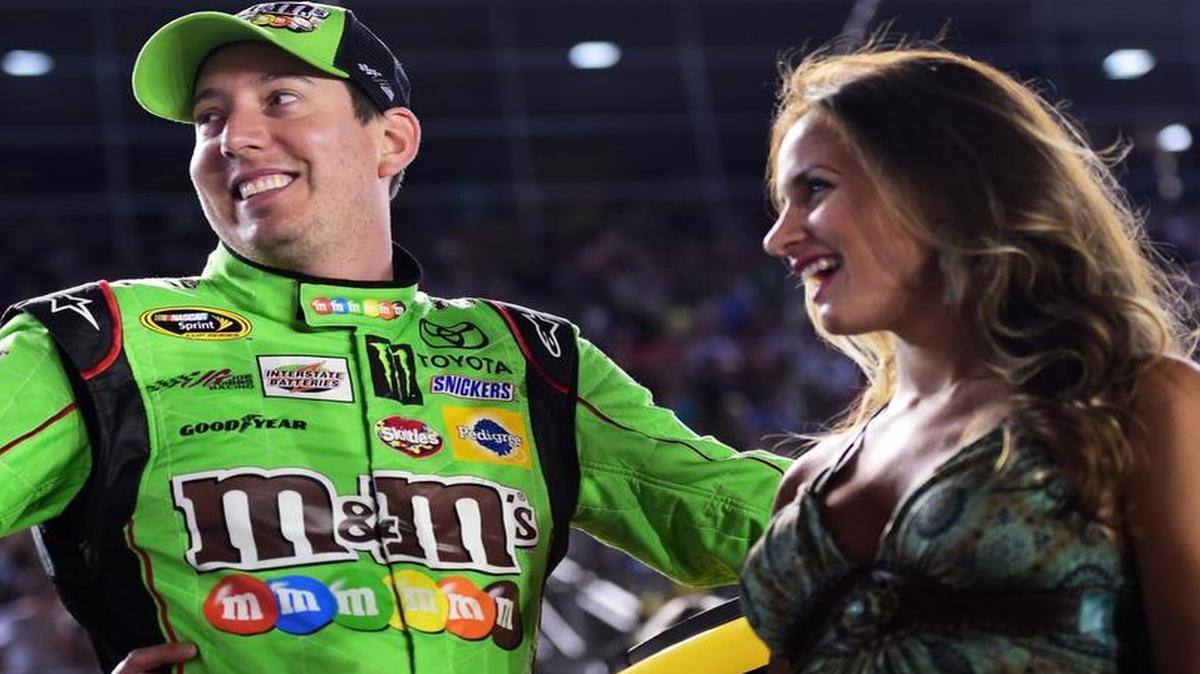 
Kyle Busch, driver of the #18 M&M's Red Nose Day Toyota, stands on the grid with his wife, Samantha, prior to the NASCAR Sprint Cup Series Sprint All-Star Race at Charlotte Motor Speedway on May 16, 2015 in Charlotte, North Carolina. 
