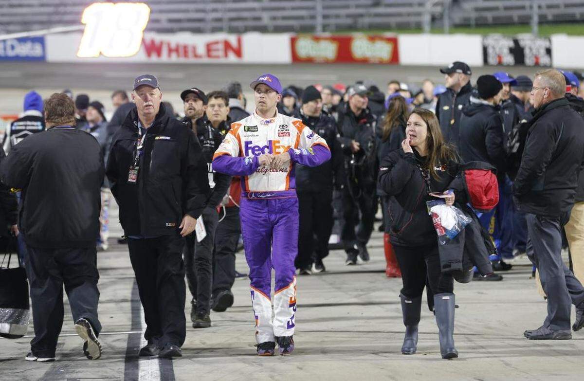 Denny Hamlin, center, leaves the track after Sunday’s NASCAR Cup series auto race at Martinsville Speedway. Hamlin wrecked with Chase Elliott during the last few laps of the race.
