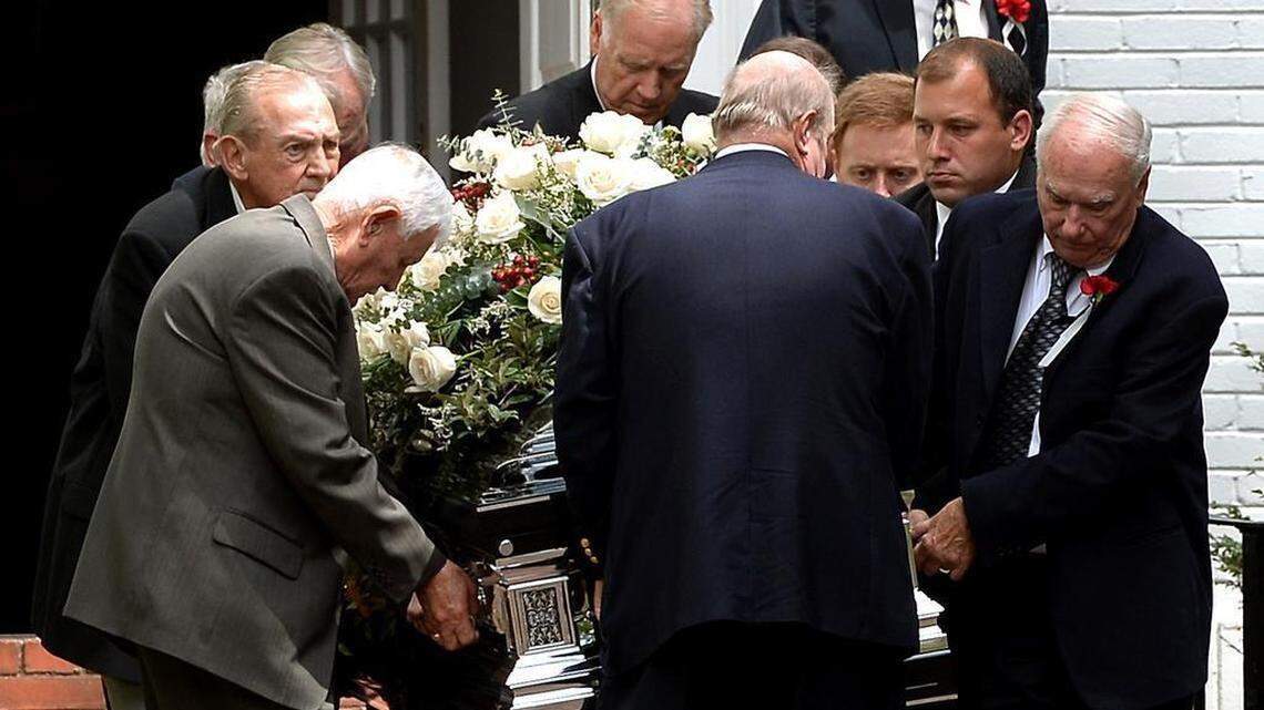 
Pallbearers carry the casket of former NASCAR driver and television commentator Buddy Baker from Avondale Presbyterian Church in Charlotte Tuesday afternoon. Baker died Aug. 10 from inoperable lung cancer. Among the pallbearers were NASCAR Sprint Cup Series driver Ryan Newman, right, looking toward flowers, and former Charlotte Observer motorsports writer Tom Higgins, second from left. At top right is former NASCAR driver Bobby Allison.
