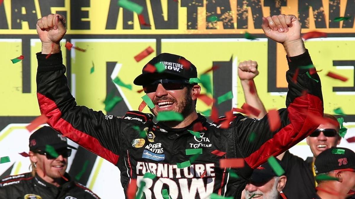 Martin Truex Jr. celebrates in Victory Lane after winning Sunday’s NASCAR Sprint Cup Series Teenage Mutant Ninja Turtles 400 at Chicagoland Speedway.