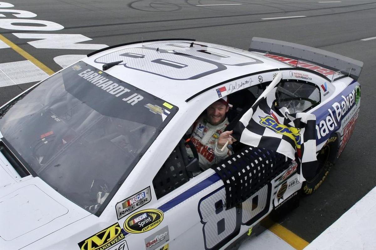 Winning is the most realistic path for Dale Earnhardt Jr. to make the NASCAR Cup Series playoffs in his final full-time season before retirement. Above, Earnhardt holds the checkered flag after winning the NASCAR Cup Series auto race at Pocono Raceway on Aug. 3, 2014.