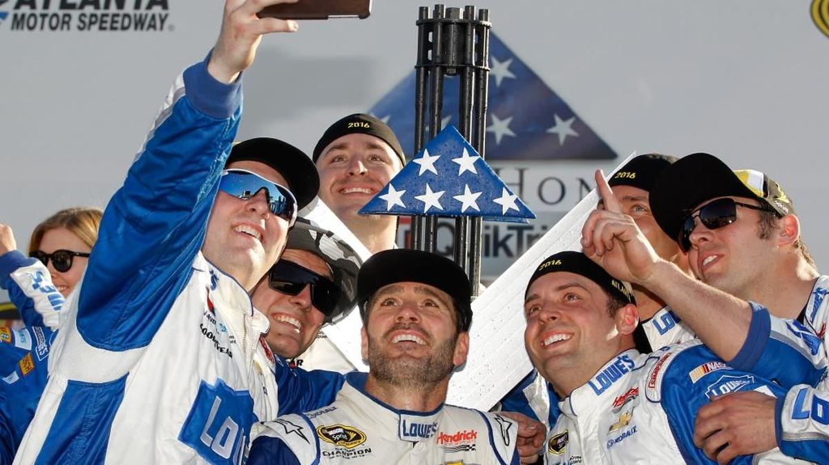 Jimmie Johnson celebrates with his crewmembers after winning Sunday’s Folds of Honor QuikTrip 500 at Atlanta Motor Speedway.