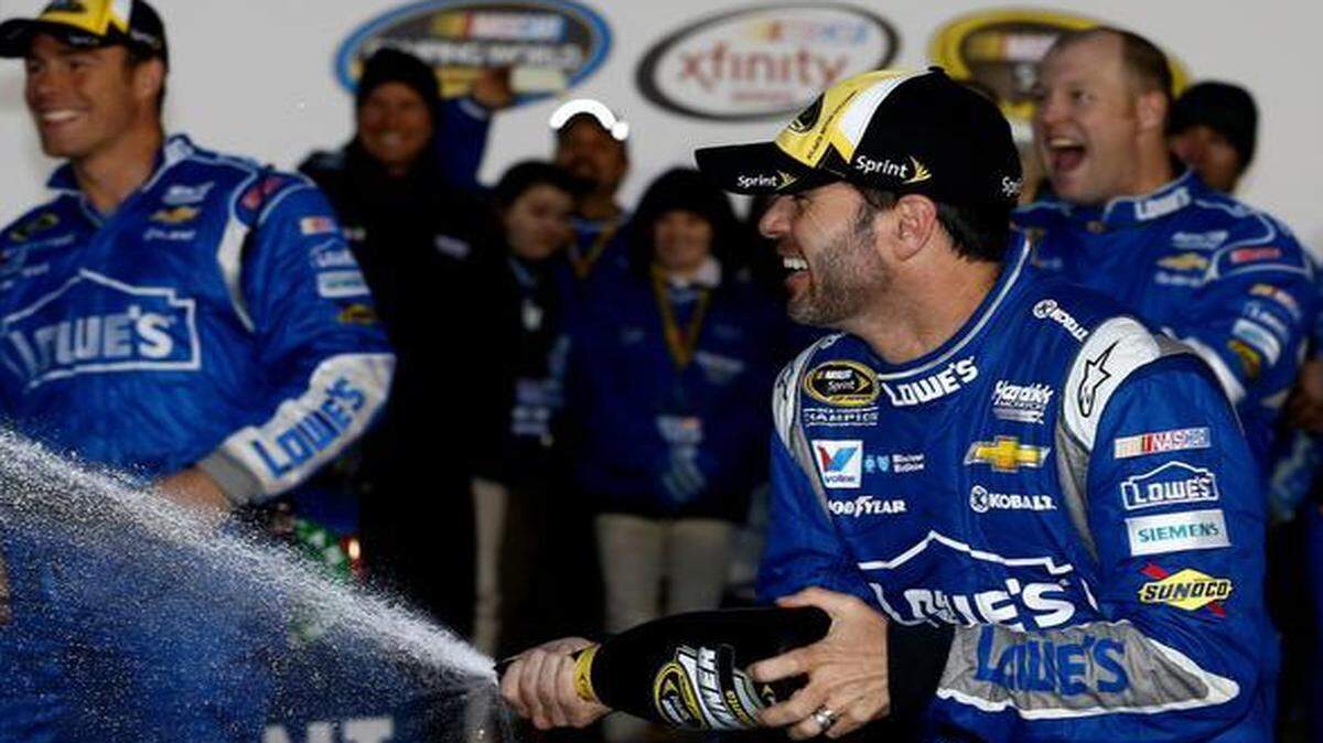 
Jimmie Johnson celebrates with champagne in victory lane after winning the NASCAR Sprint Cup Series Folds of Honor QuikTrip 500 at Atlanta Motor Speedway on Sunday, March 1, 2015 in Hampton, Ga. 
