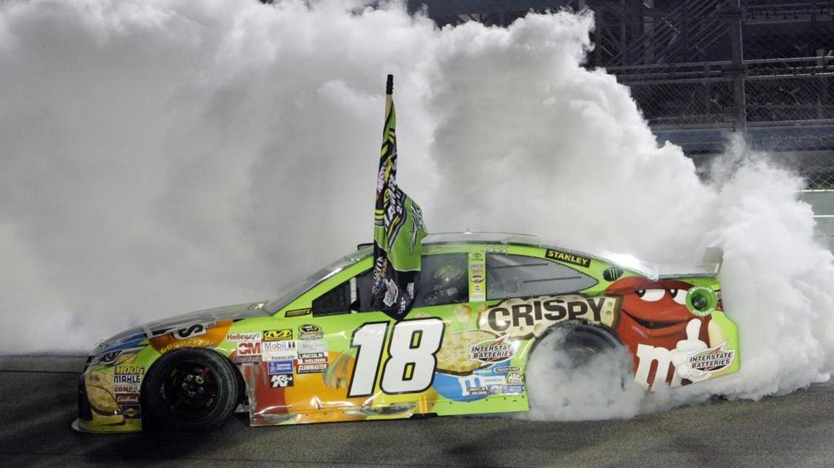 Kyle Busch does a burnout after winning Sunday’s NASCAR Sprint Cup Series auto race and the season’s Chase championship.