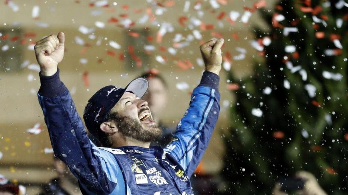 Martin Truex Jr. celebrates in Victory Lane after winning Saturday’s NASCAR Monster Cup auto race at Kansas Speedway in Kansas City, Kan