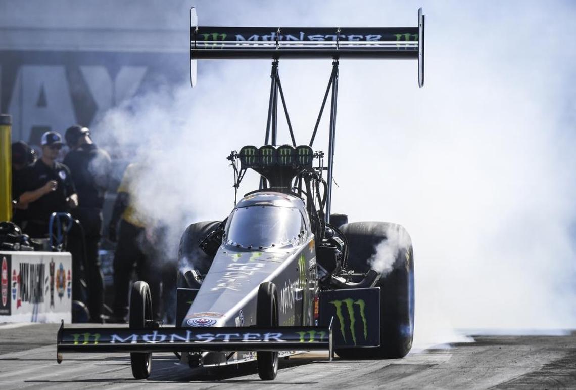 In this photo provided by the NHRA, Brittany Force takes part in Top Fuel qualifying at the NHRA Four-Wide Nationals drag races at zMAX Dragway in Concord. Her pass of 3.689 seconds at 318.39 mph set the track elapsed time record, and gave her the No. 1 spot in qualifying.