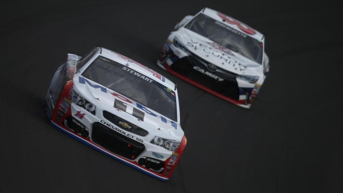 Tony Stewart, front, finished 21 st in Sunday’s Pure Michigan 400 at Michigan International Speedway and clinched a spot inside the top 30 in the points standings with two races remaining until the Chase begins. That, along with his victory at Sonoma (Calif.) Raceway in June, means three-time champion Stewart has also clinched a spot in the postseason for the first time since 2012.