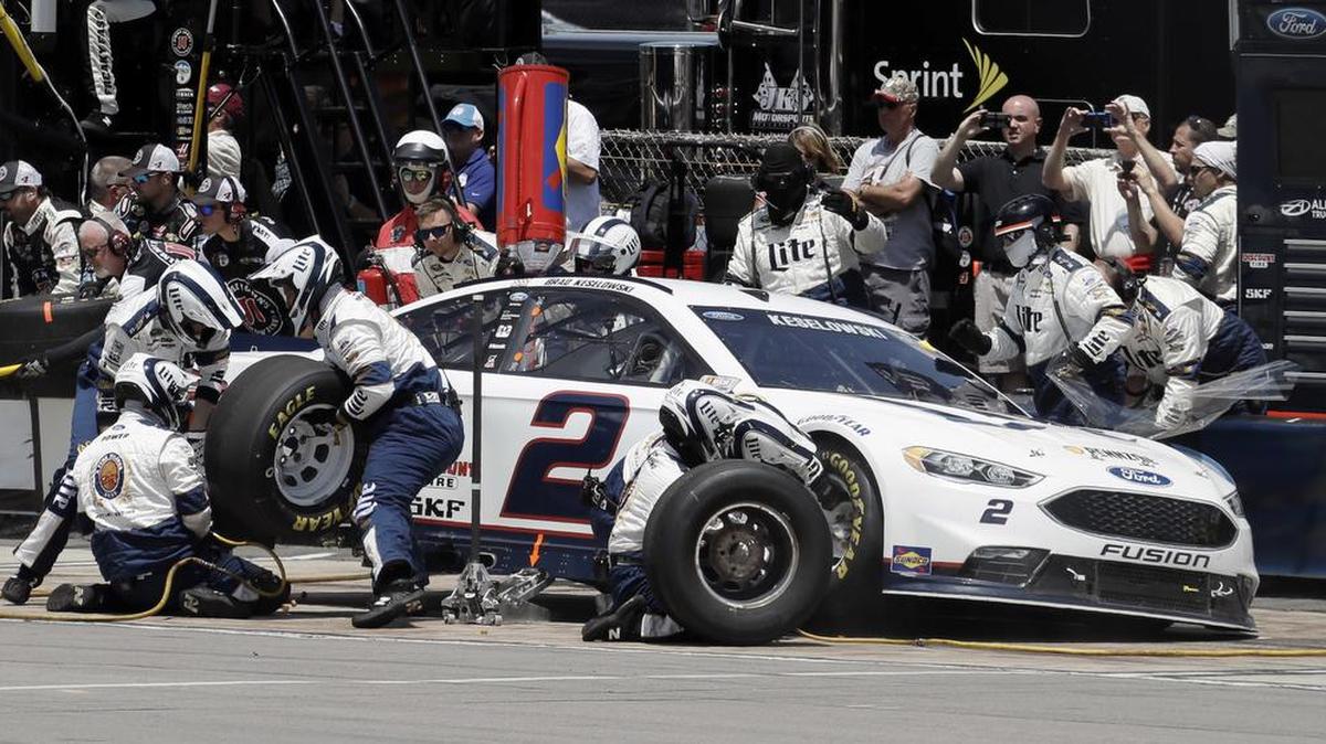 Crew members work on Brad Keselowski’s car Monday during a pit stop at Pocono Raceway in Long Pond, Pa.