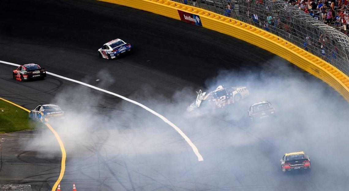 NASCAR drivers Chase Elliott, left and Brad Keselowski, right, kick up smoke during a wreck heading into Turn 1 at Charlotte Motor Speedway during Sunday’s Coca-Cola 600.