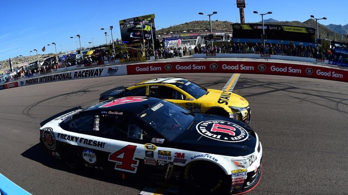 Kevin Harvick edged Carl Edwards by one-hundredth of a second to win the Good Sam 500 in a green-white-checkered finish NASCAR Sprint Cup race Sunday at Phoenix International Raceway.