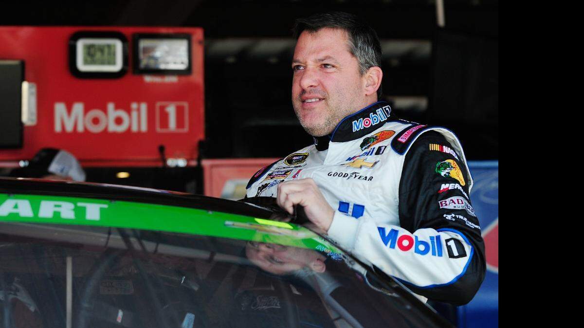 
Tony Stewart stands in the garage area during practice for Saturday night’s NASCAR Sprint Cup Series Toyota Owners 400 at Richmond International Raceway.
