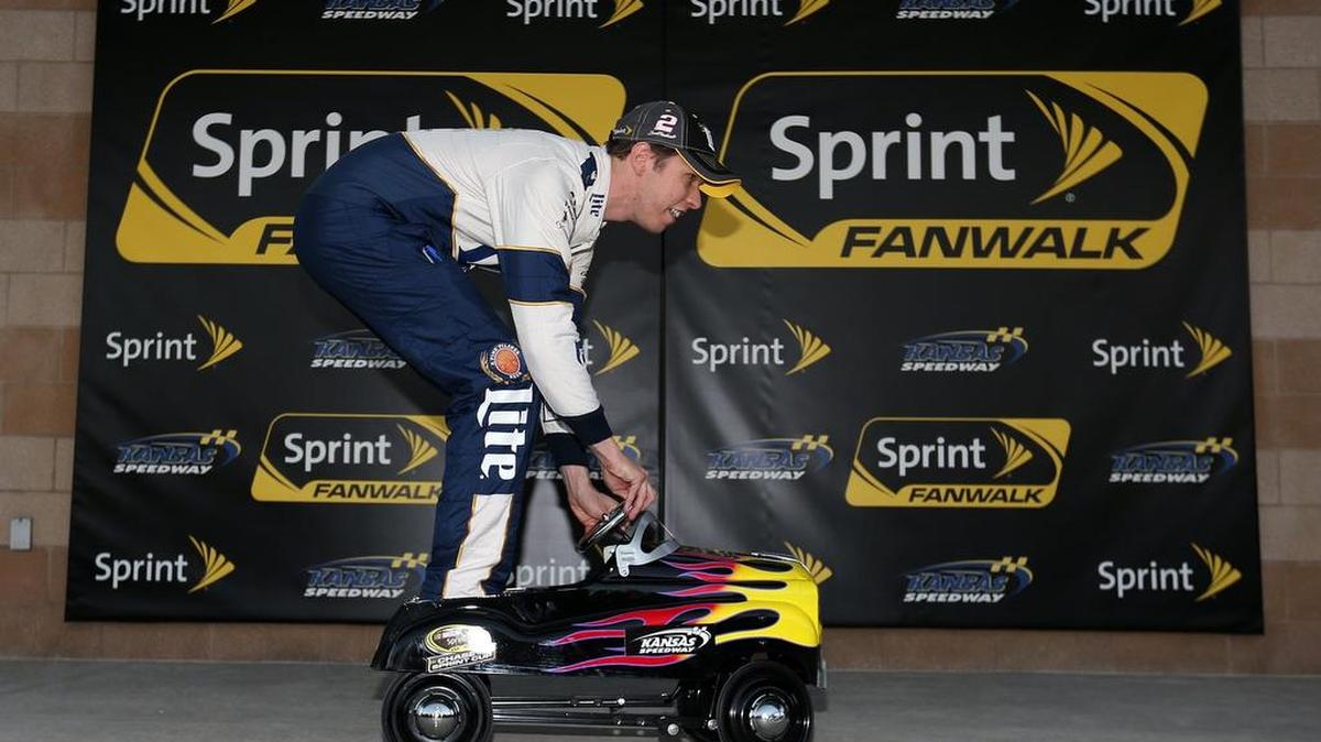 
 Brad Keselowski, driver of the #2 Miller Lite Ford, poses with the track pole award after qualifying for the pole position for the NASCAR Sprint Cup Series Hollywood Casino 400 at Kansas Speedway. 
