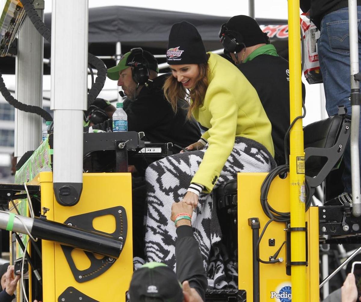 Samantha Busch fist-bumps a crew member to celebrate her husband Kyle Busch’s (18) victory in Sunday’s O’Reilly Auto Parts 500 race at Texas Motor Speedway.