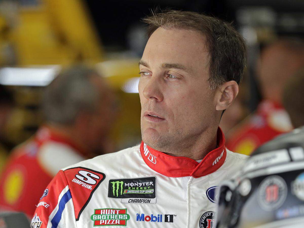 Kevin Harvick looks from the garage before practice for the NASCAR Cup series auto race at Charlotte Motor Speedway in Charlotte, N.C., Saturday, May 26, 2018. (AP Photo/Chuck Burton)