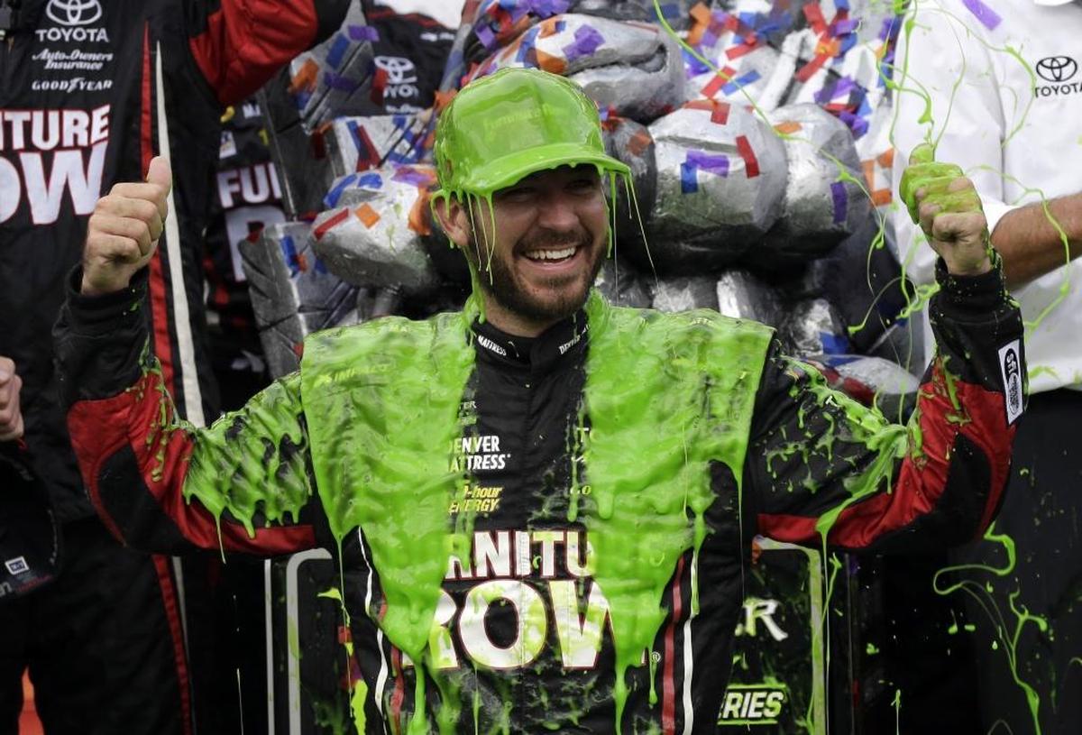 Martin Truex Jr., celebrates with his crew in Victory Lane after winning Sunday’s NASCAR Cup Monster Energy Series auto race at Chicagoland Speedway in Joliet, Ill.