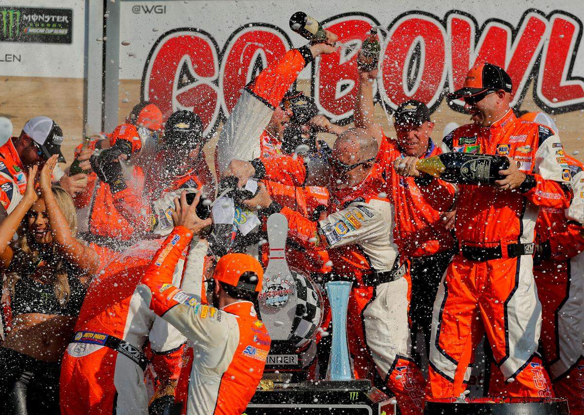Chase Elliott and his pit crew celebrate after winning a NASCAR Cup Series auto race, Sunday, Aug. 5, 2018, in Watkins Glen, N.Y. (AP Photo/Julie Jacobson)