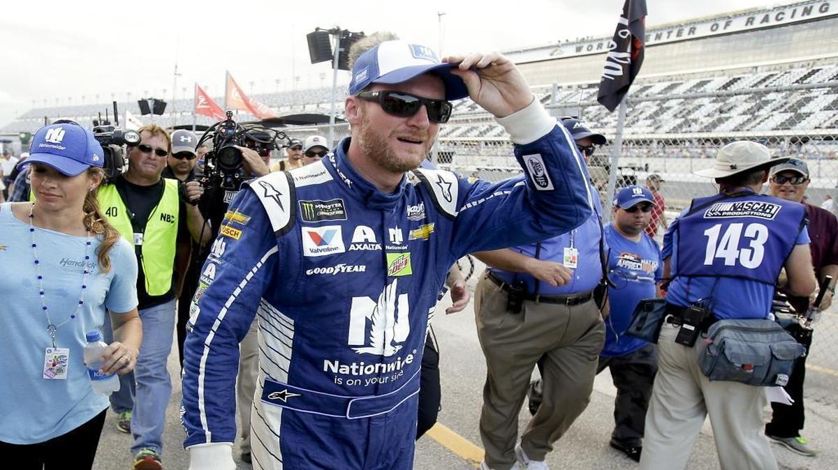 Dale Earnhardt Jr. walks back to the garage area after he won the pole position for Saturday’s Coke Zero 400 during Friday’s qualifying at Daytona International Speedway.