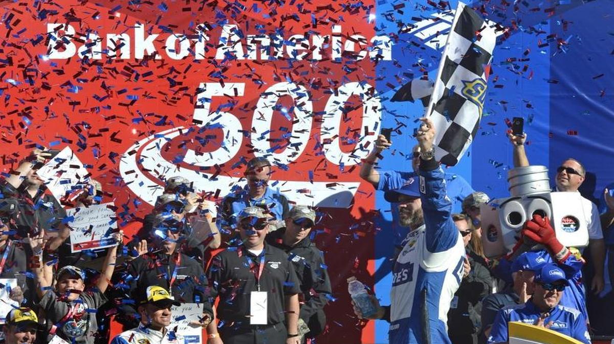 Jimmie Johnson celebrates in victory lane after winning the 37th Annual Bank of America 500 NASCAR Sprint Cup Race at Charlotte Motor Speedway.