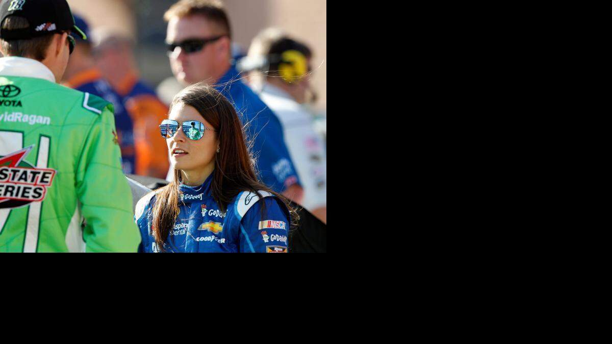 
Drivers Danica Patrick, right, and David Regan talk prior to driving in the qualifying round for Sunday's NASCAR Sprint Cup Series auto race in Fontana, Calif., Friday, March 20, 2015. 
