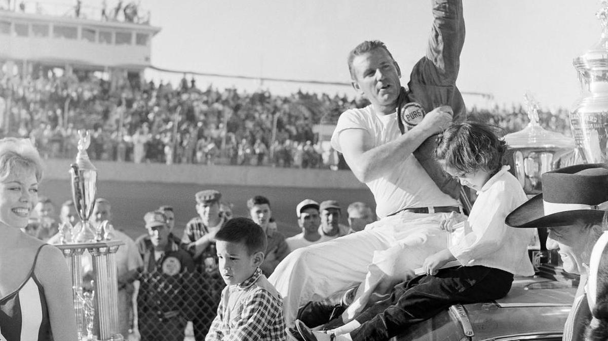 Marvin Panch, Daytona Beach winner of the 500-mile late model stock car race, waves to the crowd on Feb. 26, 1961, along with his two children.