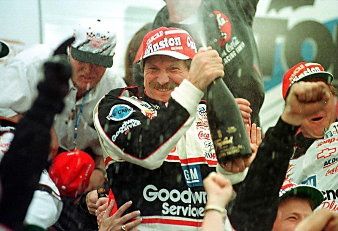 NASCAR driver Dale Earnhardt sprayed champagne over his wife and crew in Victory Lane at Daytona International Speedway after winning the 1998 Daytona 500, his first victory in NASCAR’s biggest race, on his 20th attempt.