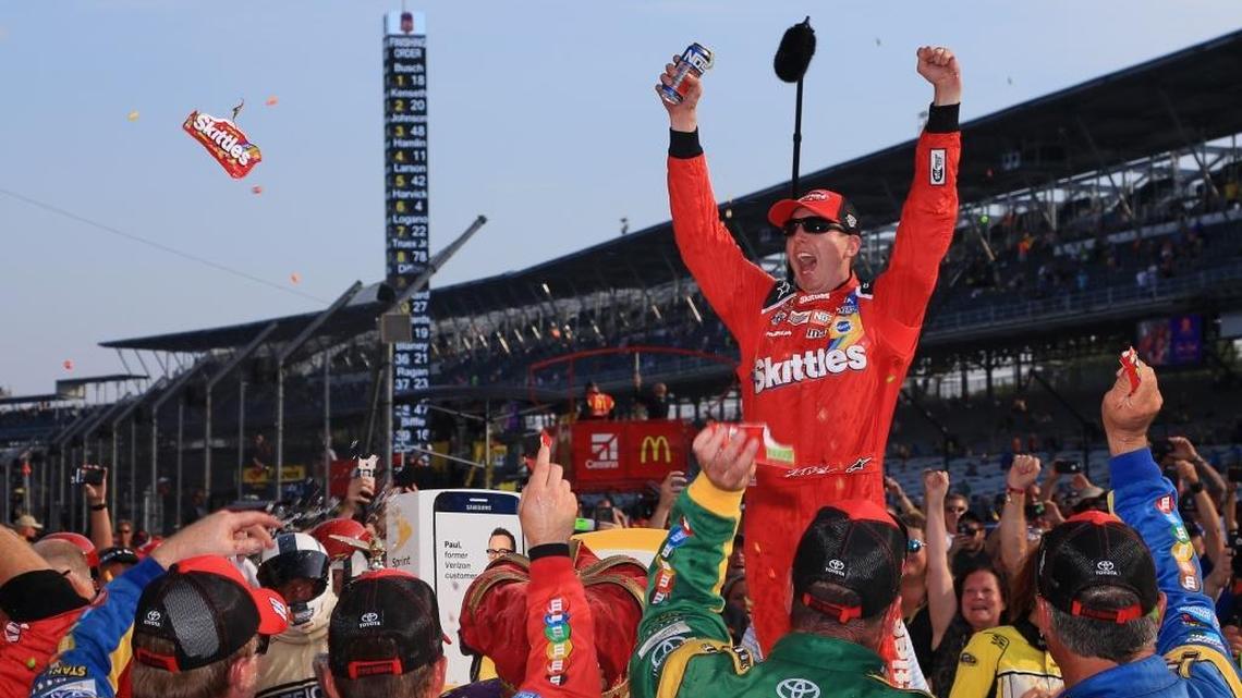 Kyle Busch, driver of the #18 Skittles Toyota, celebrates in victory lane after winning the NASCAR Sprint Cup Series Crown Royal Presents the Combat Wounded Coalition 400 at Indianapolis Motor Speedway on July 24, 2016 in Indianapolis, Indiana.