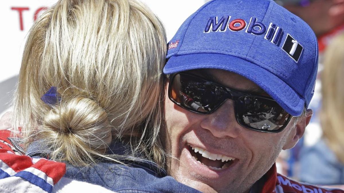 Kevin Harvick embraces his wife, DeLana Harvick, after winning Sunday’s NASCAR Sprint Cup Series auto race Sunday in Sonoma, Calif.