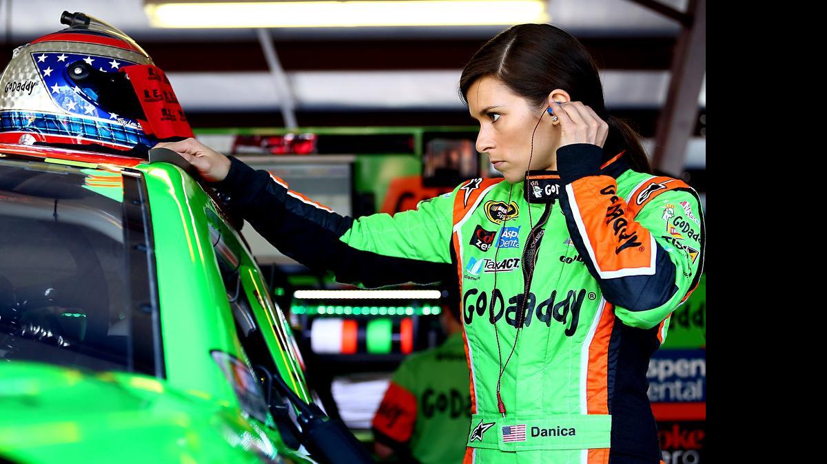 Danica Patrick, driver of the #10 GoDaddy Chevrolet, stands in the garage area during practice for the NASCAR Sprint Cup Series GEICO 500 at Talladega Superspeedway on May 1, 2015 in Talladega, Alabama.