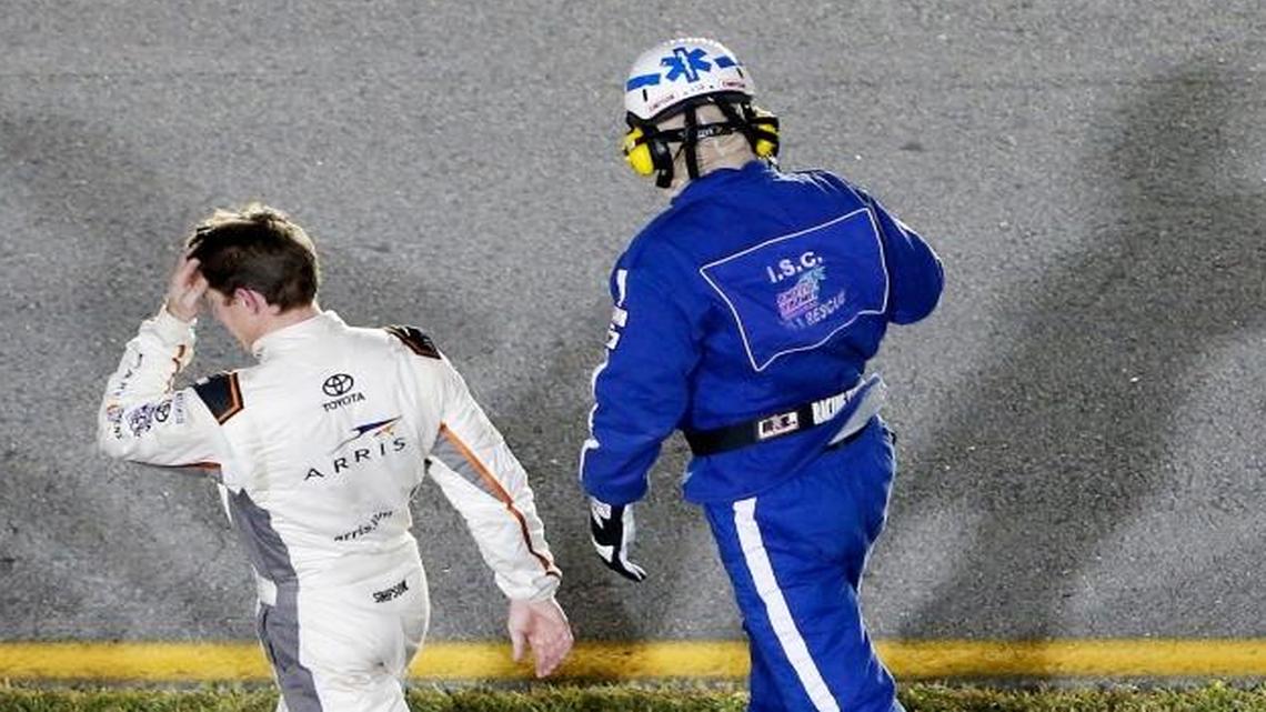 Carl Edwards walks to the infield after being involved in an on-track incident during Sunday’s NASCAR Sprint Cup Series race at Homestead-Miami Speedway.