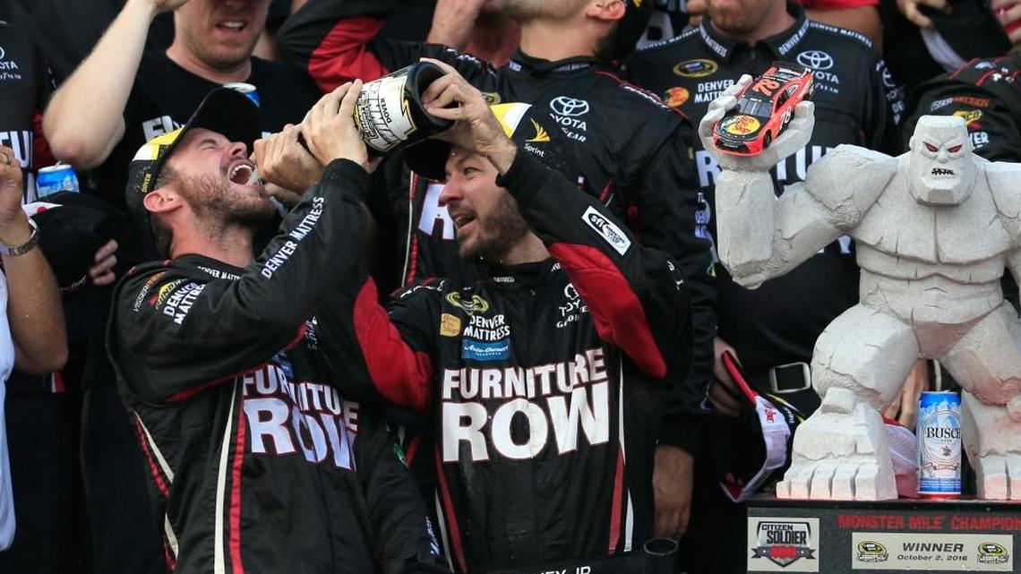 Martin Truex Jr. celebrates with the trophy in Victory Lane after winning Sunday’s NASCAR Sprint Cup Series Citizen Soldier 400 at Dover International Speedway.