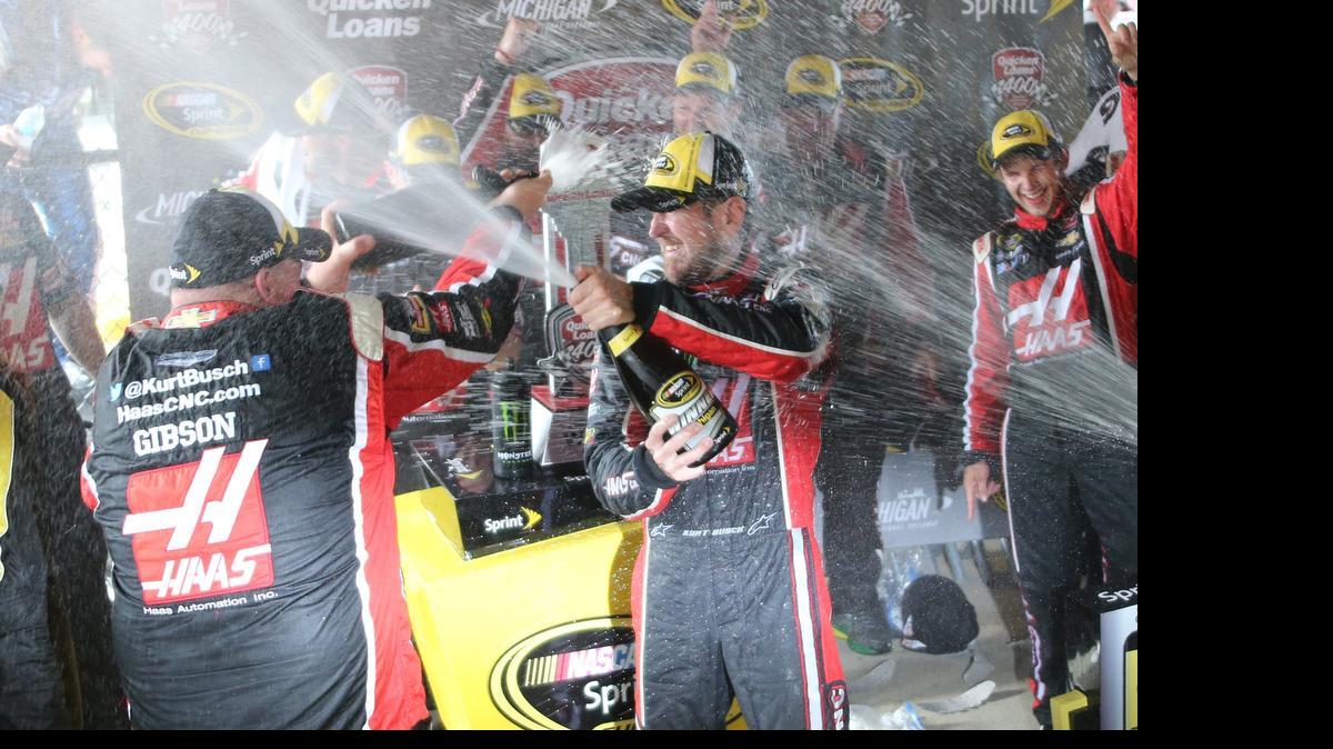 
Kurt Busch celebrates with teammates after winning the NASCAR Sprint Cup series auto race at Michigan International Speedway, Sunday, June 14, 2015, in Brooklyn, Mich. 
