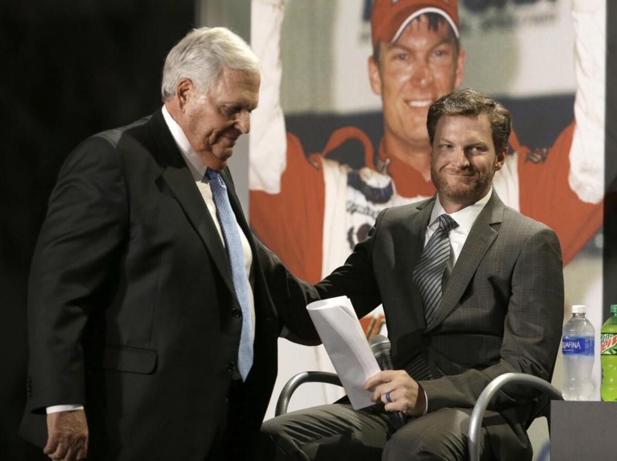 Dale Earnhardt Jr, right, reaches out to team owner Rick Hendrick during a news conference at Hendrick Motorsports in Concord on Tuesday.