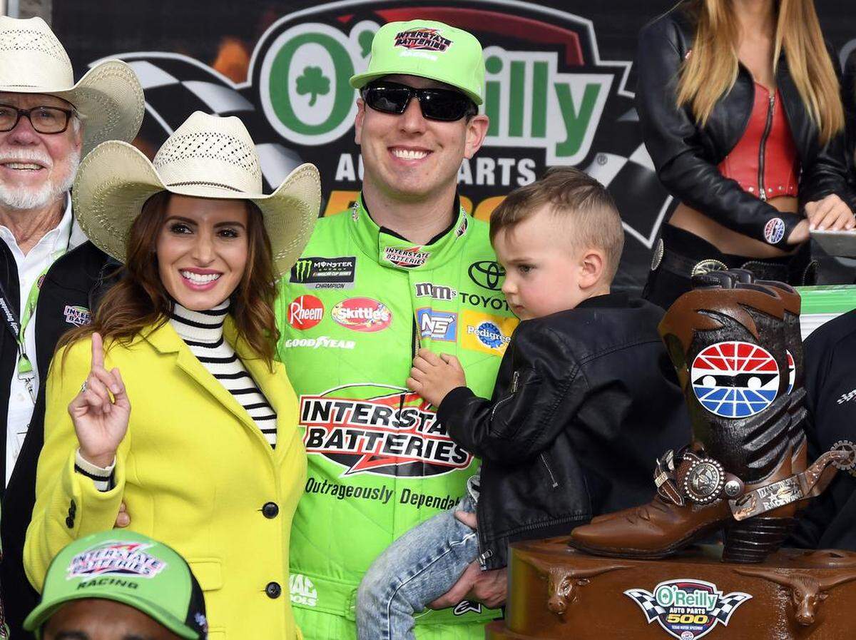 Kyle Busch, center poses by the trophy with his wife, Samantha, left, and son, right, after winning Sunday's O’Reilly Auto Parts 500 at Texas Motor Speedway.
