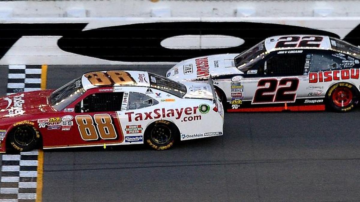 NASCAR Xfinity Series driver Chase Elliott crosses the finish line to win the Powershares QQQ 300 at Daytona International Speedway as Joey Logano finishes second on Saturday.