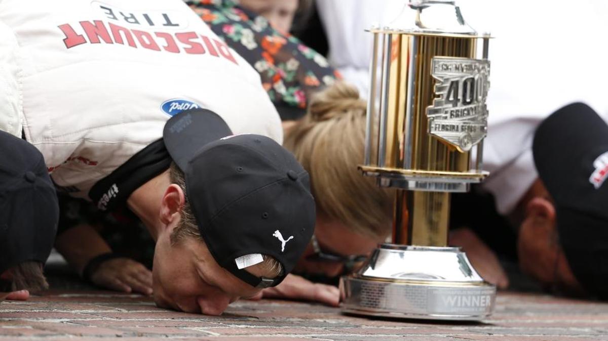 NASCAR Cup Series driver Brad Keselowski (2) kisses the yard of bricks on the start/finish line after winning the NASCAR Brickyard 400 on Monday.