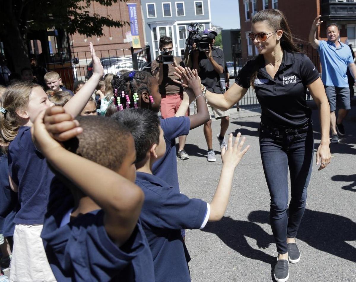 NASCAR driver Danica Patrick greets students Wednesday from Charlestown's Warren-Prescott school before taking a tour of historic sites in Boston.