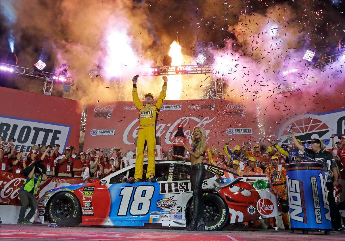 Kyle Busch celebrates after winning the NASCAR Cup Series auto race at Charlotte Motor Speedway in Charlotte, N.C., Sunday, May 27, 2018. (AP Photo/Chuck Burton)