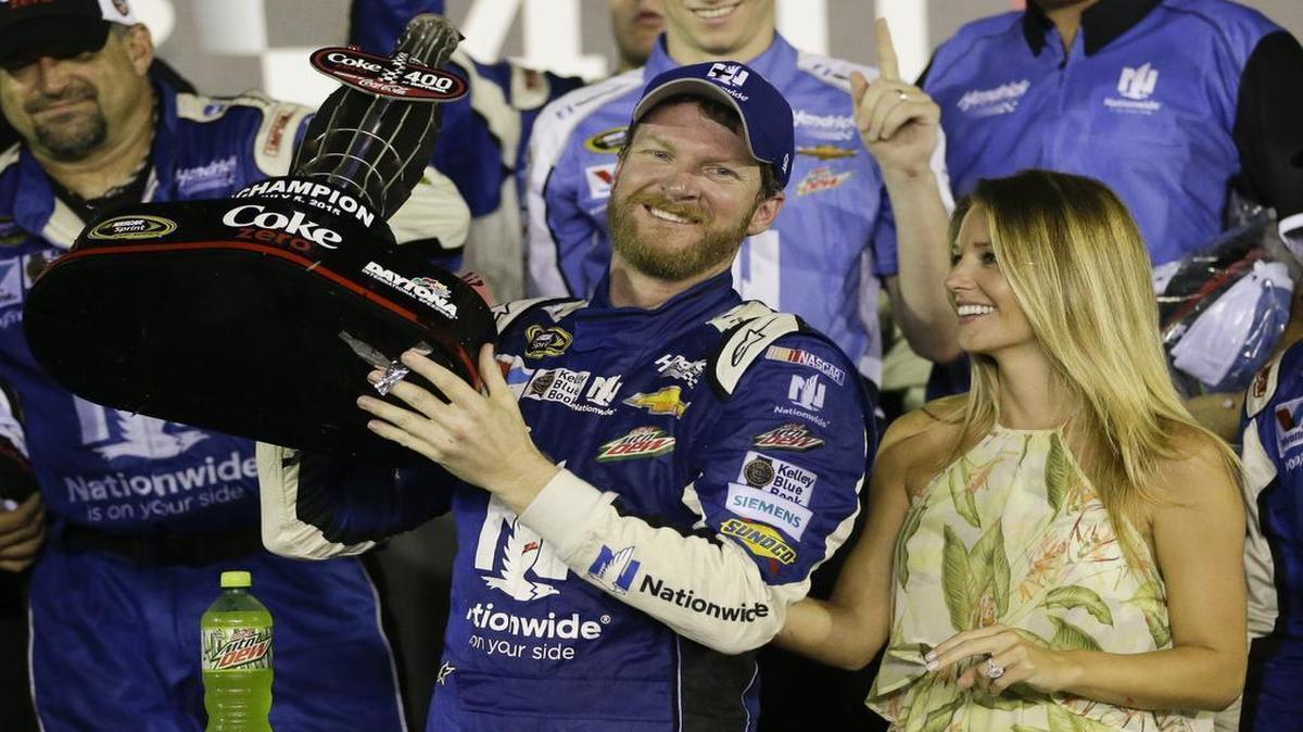 
Dale Earnhardt Jr. and fiance Amy Reimann, right, celebrate after Earnhardt won the NASCAR Sprint Cup series Coke Zero 400 at Daytona International Speedway early Monday morning. 
