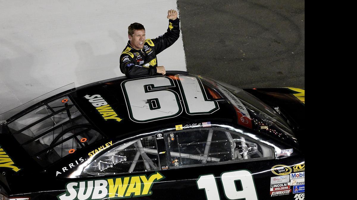 
NASCAR Sprint Cup Series driver Carl Edwards celebrates his victory in the Coca-Cola 600 at Charlotte Motor Speedway on Sunday, May 24, 2015.

