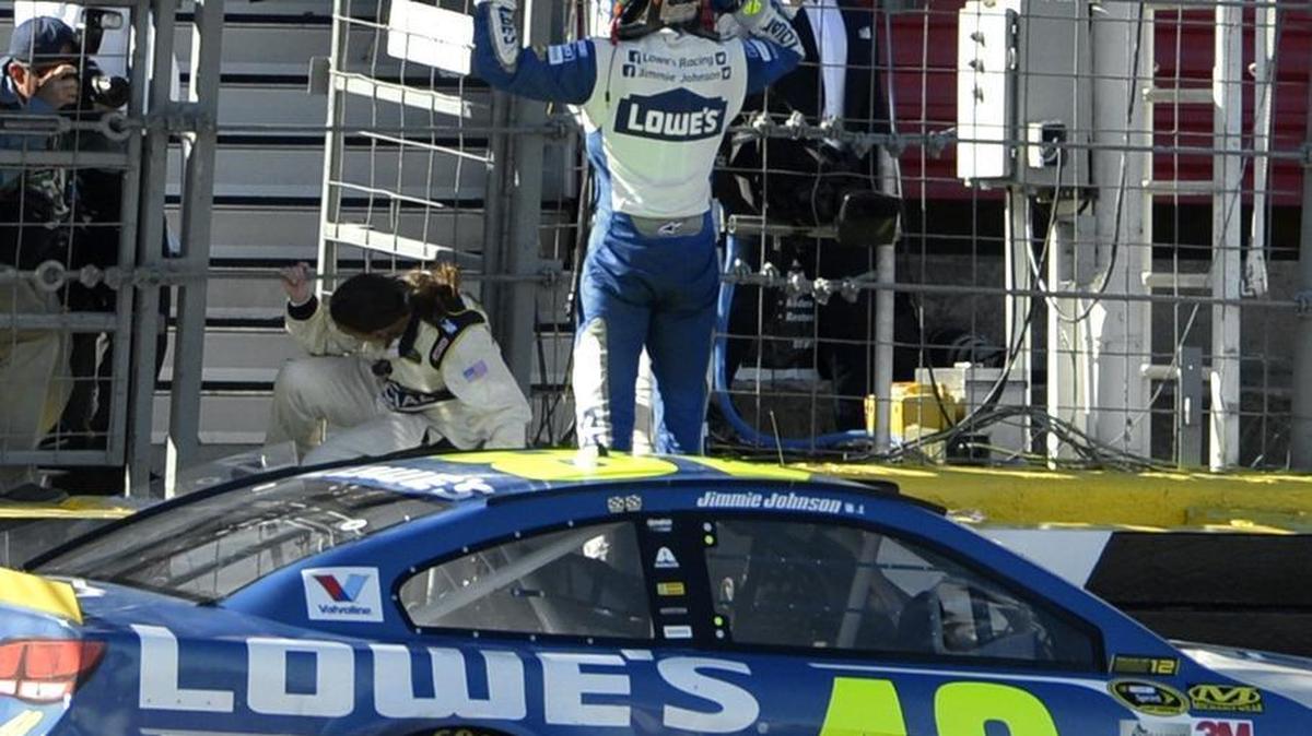 Jimmie Johnson celebrates after winning the 37th Annual Bank of America 500 NASCAR Sprint Cup Race at Charlotte Motor Speedway, Sunday, October 9, 2016.