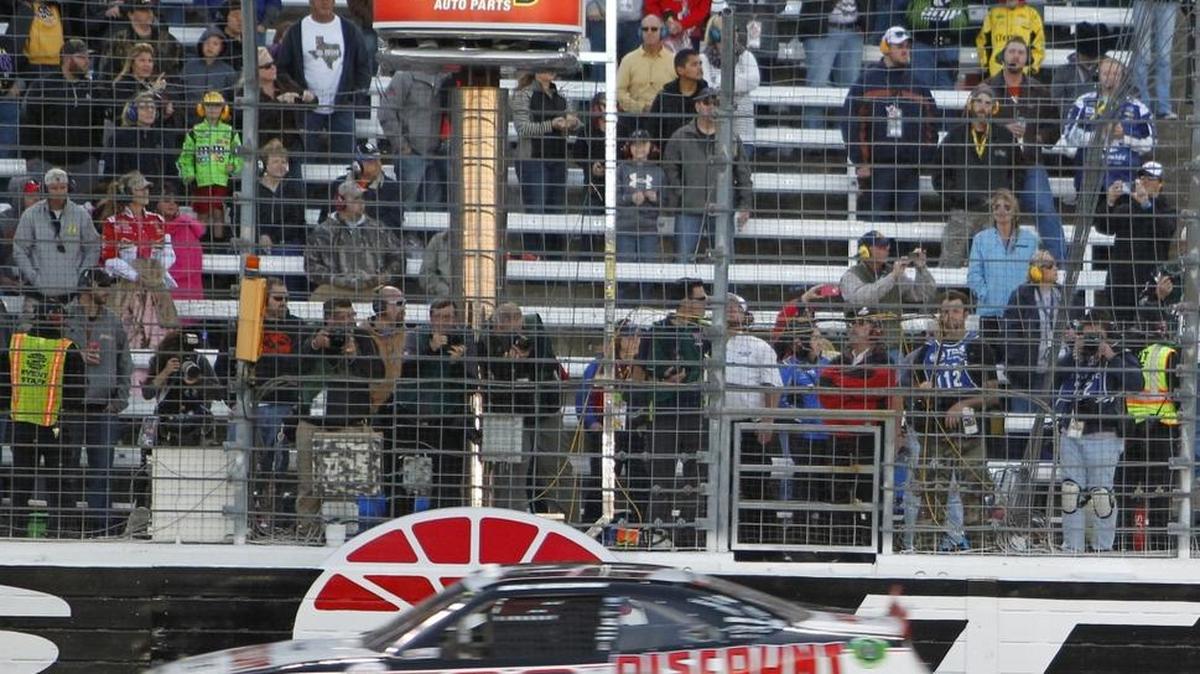 Brad Keselowski flashes across the finish line to win the NASCAR Xfinity Series O'Reilly Auto Parts Challenge on Saturday at Texas Motor Speedway in Fort Worth, Texas.