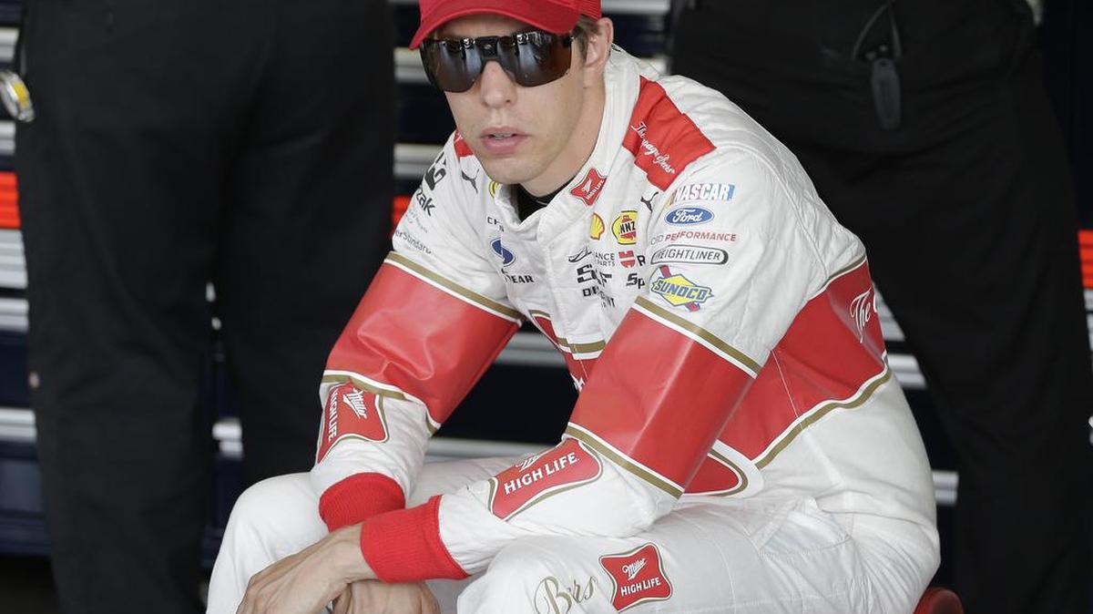 
Brad Keselowski sits on a piece of equipment in the garage during a NASCAR Sprint Cup practice session at Darlington Raceway in Darlington, S.C., Friday. 
