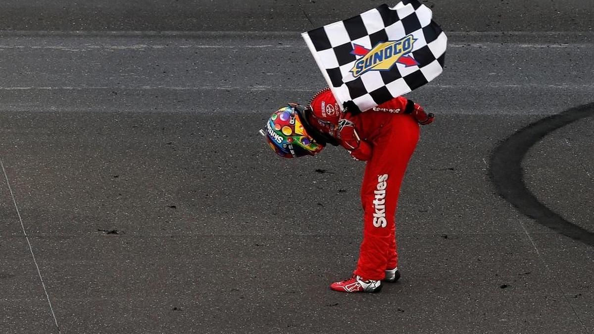 Kyle Busch, driver of the #18 Skittles Toyota, celebrates after winning the NASCAR Sprint Cup Series Crown Royal Presents the Combat Wounded Coalition 400 at Indianapolis Motor Speedway on July 24, 2016 in Indianapolis, Indiana.
