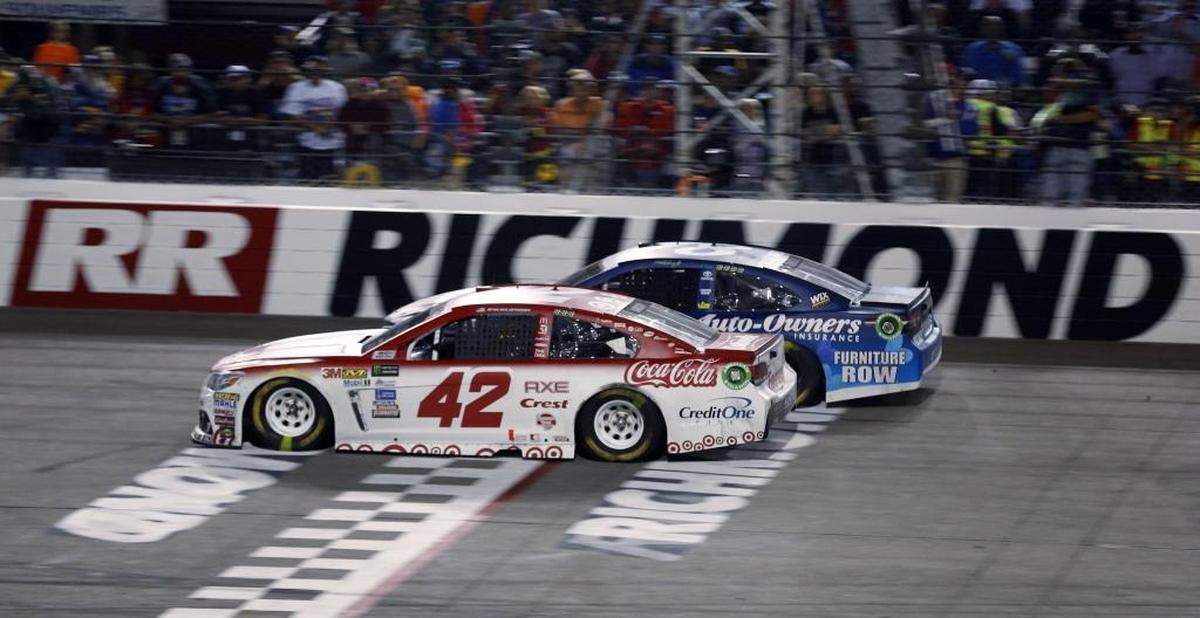 Kyle Larson (42) passes Martin Truex, Jr., (78) on the final restart to win Saturday’s NASCAR Cup Series auto race at Richmond Raceway in Richmond, Va. The pair are the top two seeds in NASCAR’s playoffs, which begin next weekend.